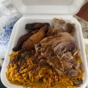 Yellow rice and peas, pork , plantains , and oxtail gravy
