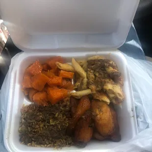 large veggie plate with curry sauce on rice and peas and mac and cheese.