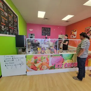 two people standing in front of the counter