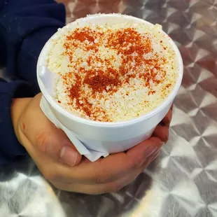 a person holding a bowl of ice cream
