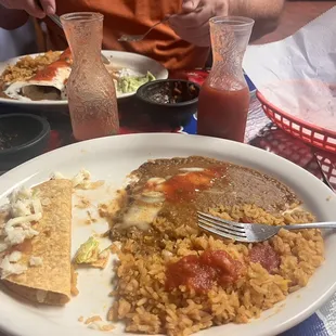 a plate of food with rice and meat