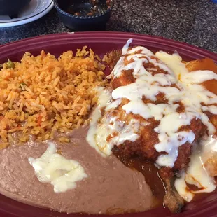 Chille rellenos, enchilada, rice and beans.