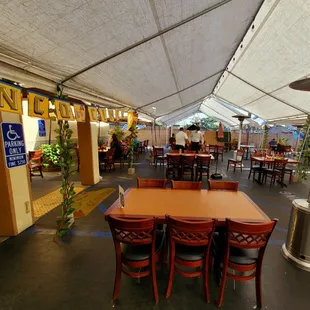 tables and chairs under a canopy