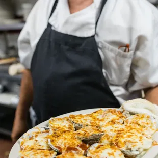 a chef holding a plate of food