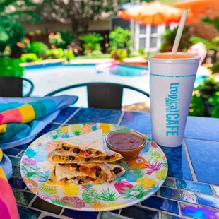 a plate of quesadillas and a drink