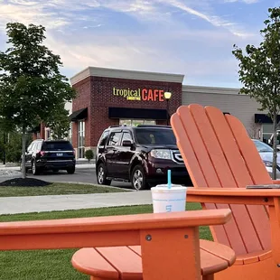 two orange chairs in front of a store