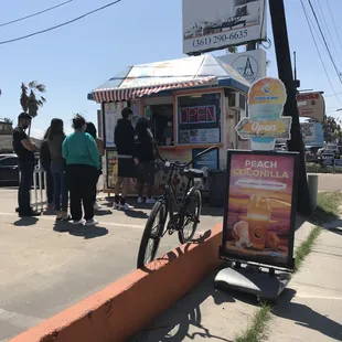 a bike parked in front of a food stand