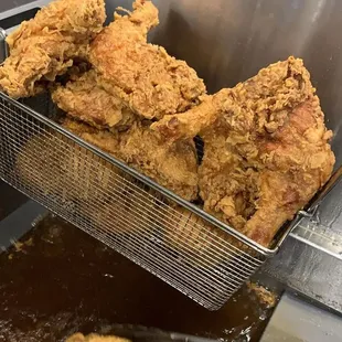 fried chicken being cooked in a fryer