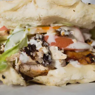 a chicken sandwich with lettuce and tomato