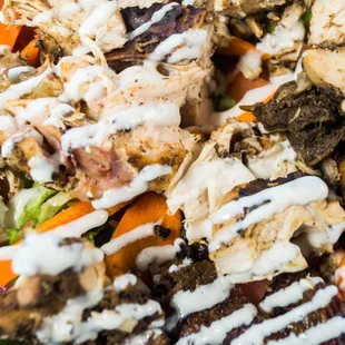 a salad with chicken, carrots, and lettuce