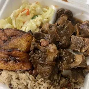 Medium oxtail with rice and peas, plantain, and cabbage...very good!