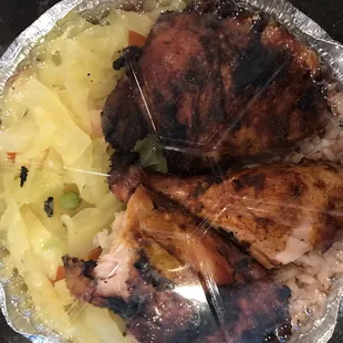 Jerk chicken with cabbage and rice.