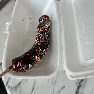 Frozen chocolate banana with sprinkles