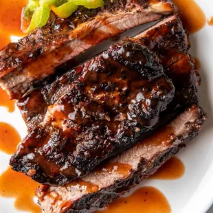 a plate of ribs with bbq sauce