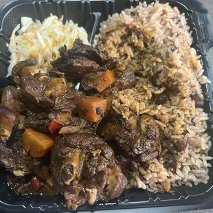 Stew chicken with rice and gravy.