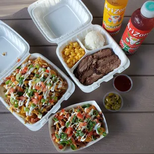 Loaded tator tots topped with pulled pork (small bowl), pulled pork nachos, and plate lunch with brisket and mac &amp; cheese as the side choice