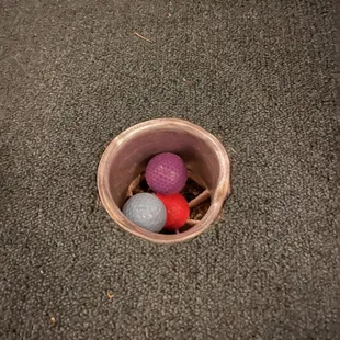 three balls in a cup