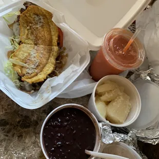 Bistec Jibarito (steak plantain sandwich), Yuca con Mojo, Frijoles Negros, Mamey Smoothie