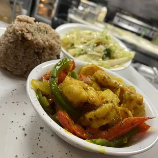 Our curry shrimp, served with rice n peas and cabbage