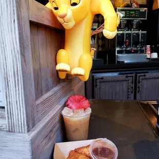 a cup of coffee and a lion statue