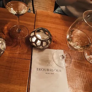 table with wine glasses and menu