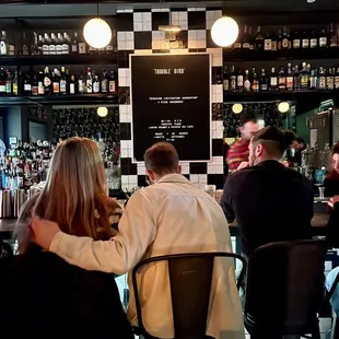 a group of people sitting at a bar