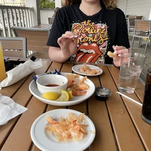 a woman eating shrimp