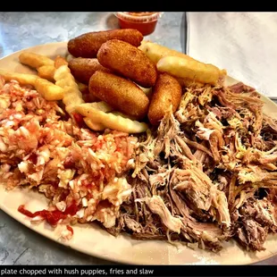 a plate of pulled pork, fries and coleslaw