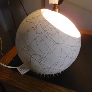 A 1950s eyeball lamp with the original stand - you can use it on a table or you can hang it from the ceiling.