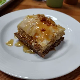 Baklava  a layered pastry dessert made of filo pastry, filled with chopped nuts, and sweetened with syrup or honey. .