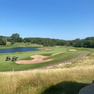 The lovely 10th hole, requiring a drive to a tight landing area between this bunker and the water, then a mid-iron into a small green.