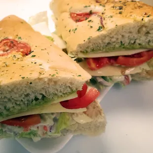 two halves of a sandwich on a plate