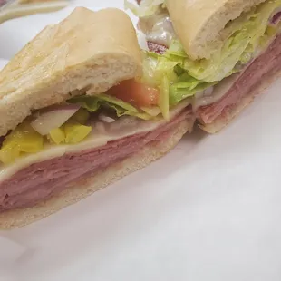 a sub sandwich on a white plate