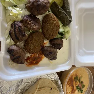Beef kofte and falafel in a rice bowl with a side of spicy hummus.
