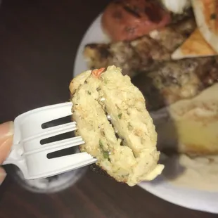 a fork holding a piece of food