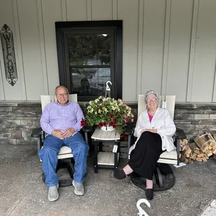 a man and a woman sitting in rocking chairs