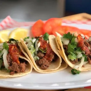 Delicious marinated carne asada, chicken or chorizo with our house salsa roja or verde!