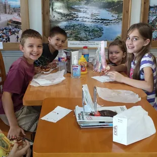 a group of children sitting at a table