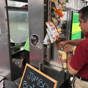 a man ordering food from a food truck
