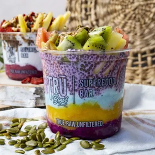 two bowls of fruit and nuts