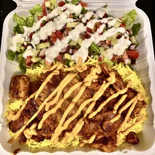 Chicken and Rice Dinner Plate.  Grilled Chicken, Basmati Rice, Lettuce Pico, Ranch Dressing, Chipotle Sour  Cream Drizzle.