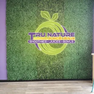 the tru nature logo on the wall