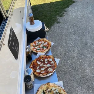 three pizzas on a table
