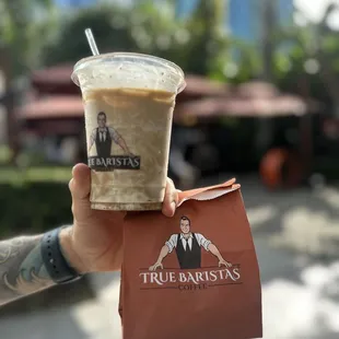 a hand holding a cup of coffee