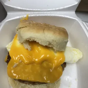 Cheese melting over sausage and biscuit