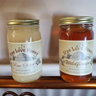 two jars of honey on a shelf