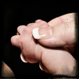 Me holding my tiny newborn's hand.  Solar courtesy of the remarkable TruElegance salon.