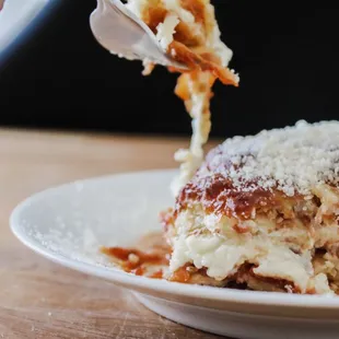 a piece of lasagna being eaten