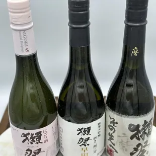 three bottles of sake on a table