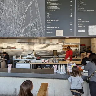 Inside. Open kitchen and wall menu above.